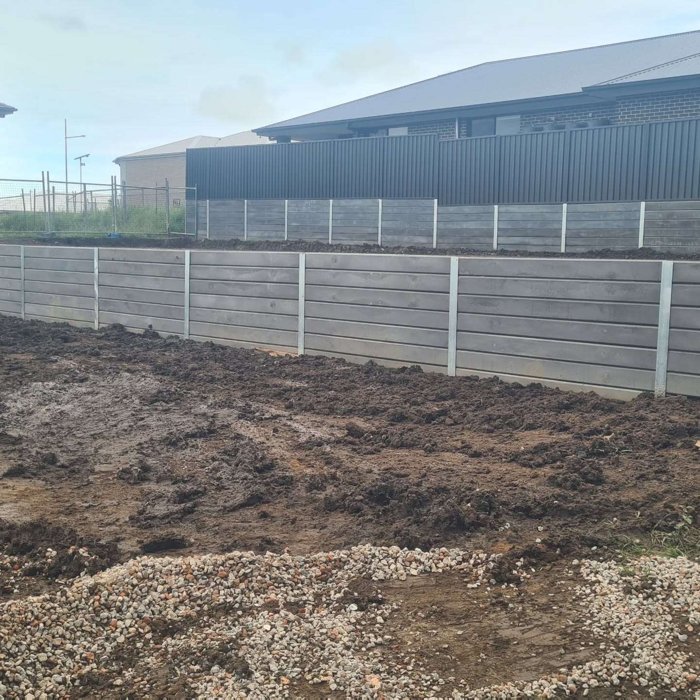 Grey timber-look concrete sleeper retaining wall built by Retain by Theo in Wollongong