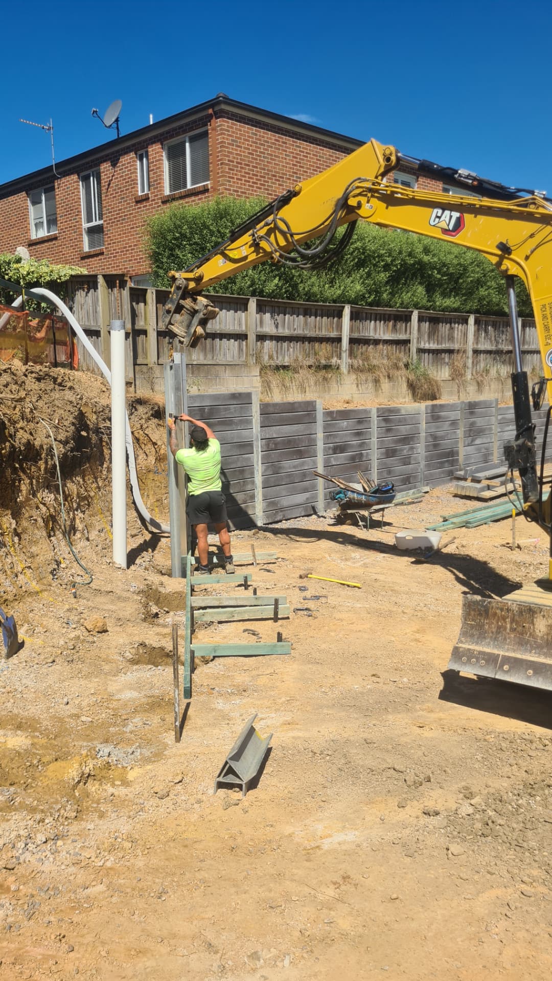 Retain by Theo installing steel posts for a concrete sleeper retaining wall on a Wollongong site